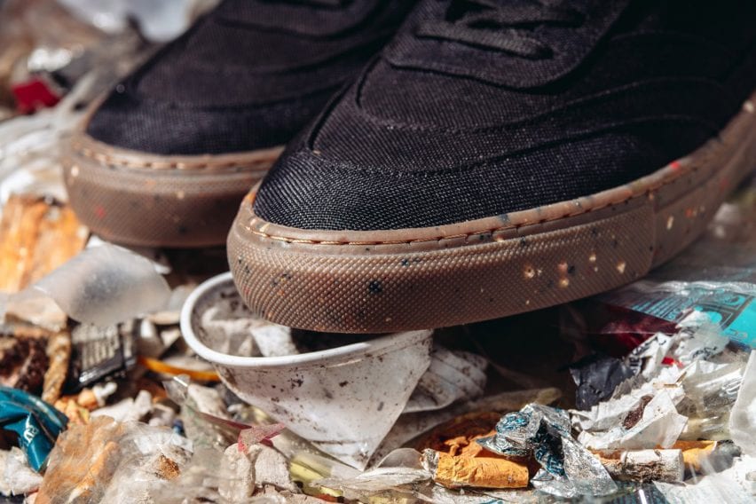 A pair of black trainers with a brown rubber sole
